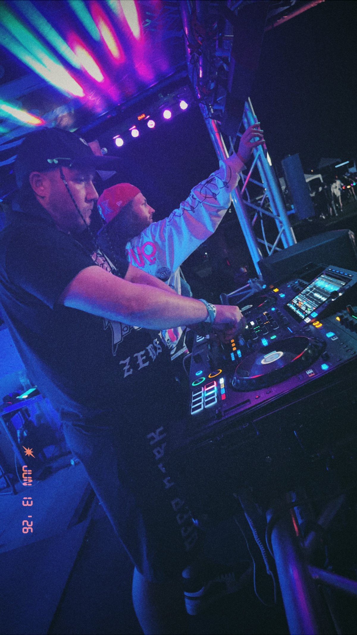 DJ DHow performing live under event lighting during open dancing.