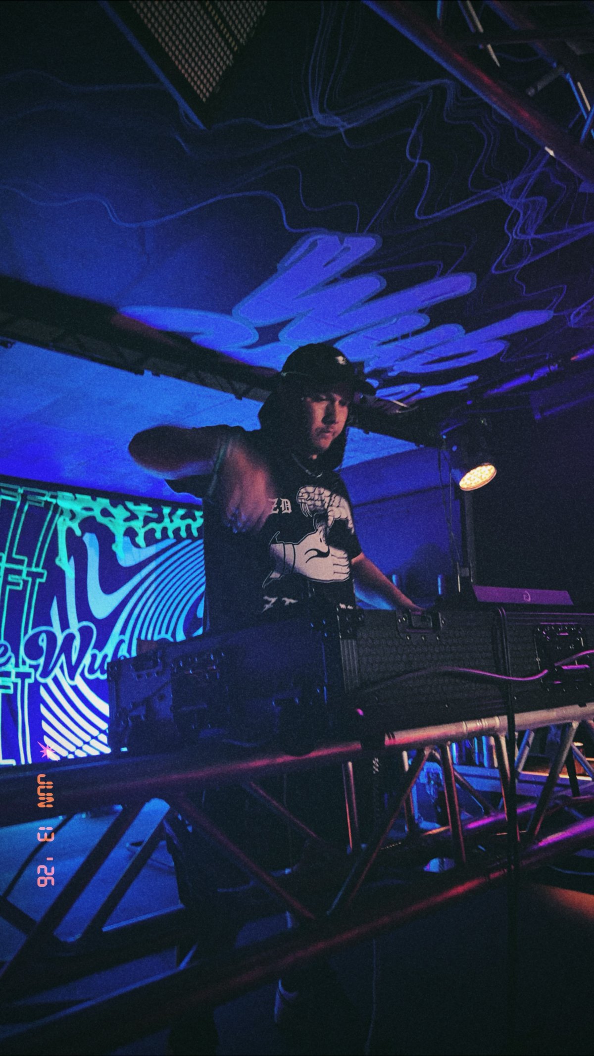 DJ DHow performing during an evening event.